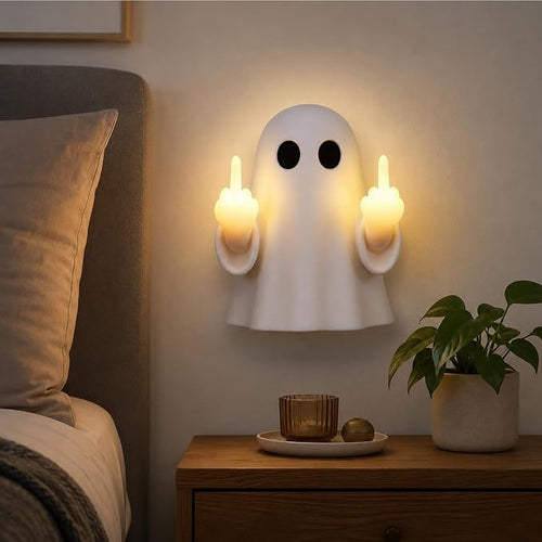 Cheeky ghost LED wall light glowing above a nightstand