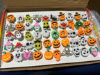 A box of pumpkin, ghost and skull light-up rings