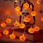 Pumpkin string lights on a spooky shelf