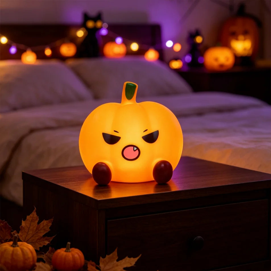 Grumpy Pumpkin night light glowing on a nightstand