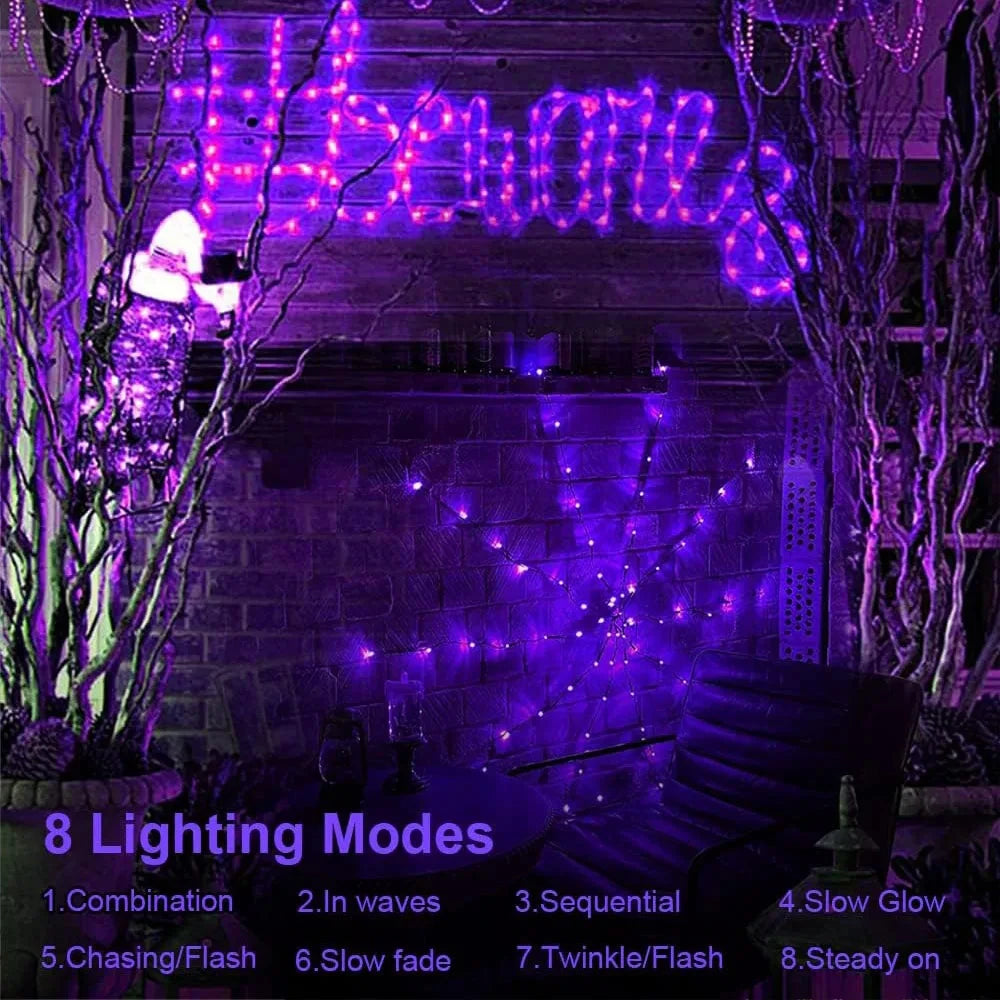 Purple LED spider web lights glowing on a haunted house at night