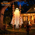 Swinging ghost hung from a tree in the yard