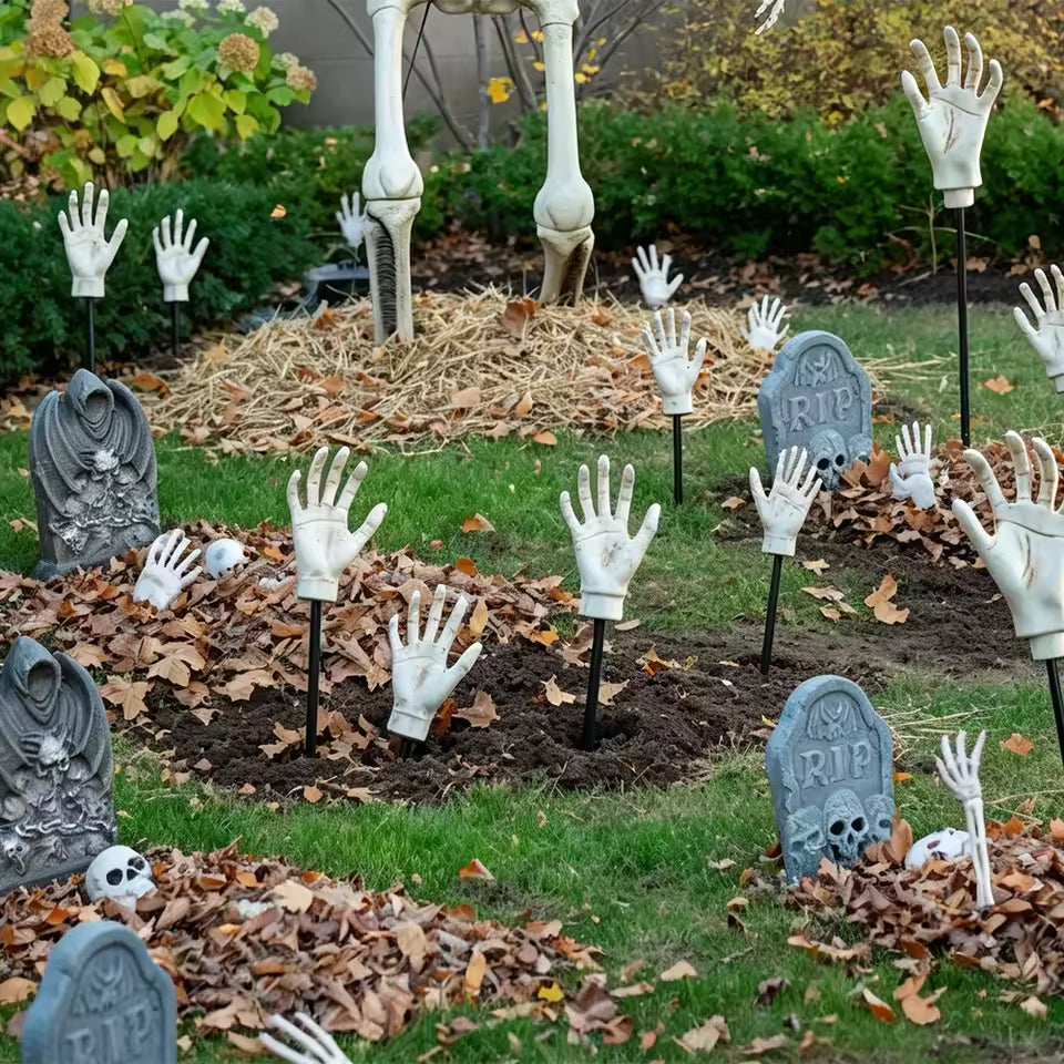 Skeleton arm stakes rising from a front lawn graveyard