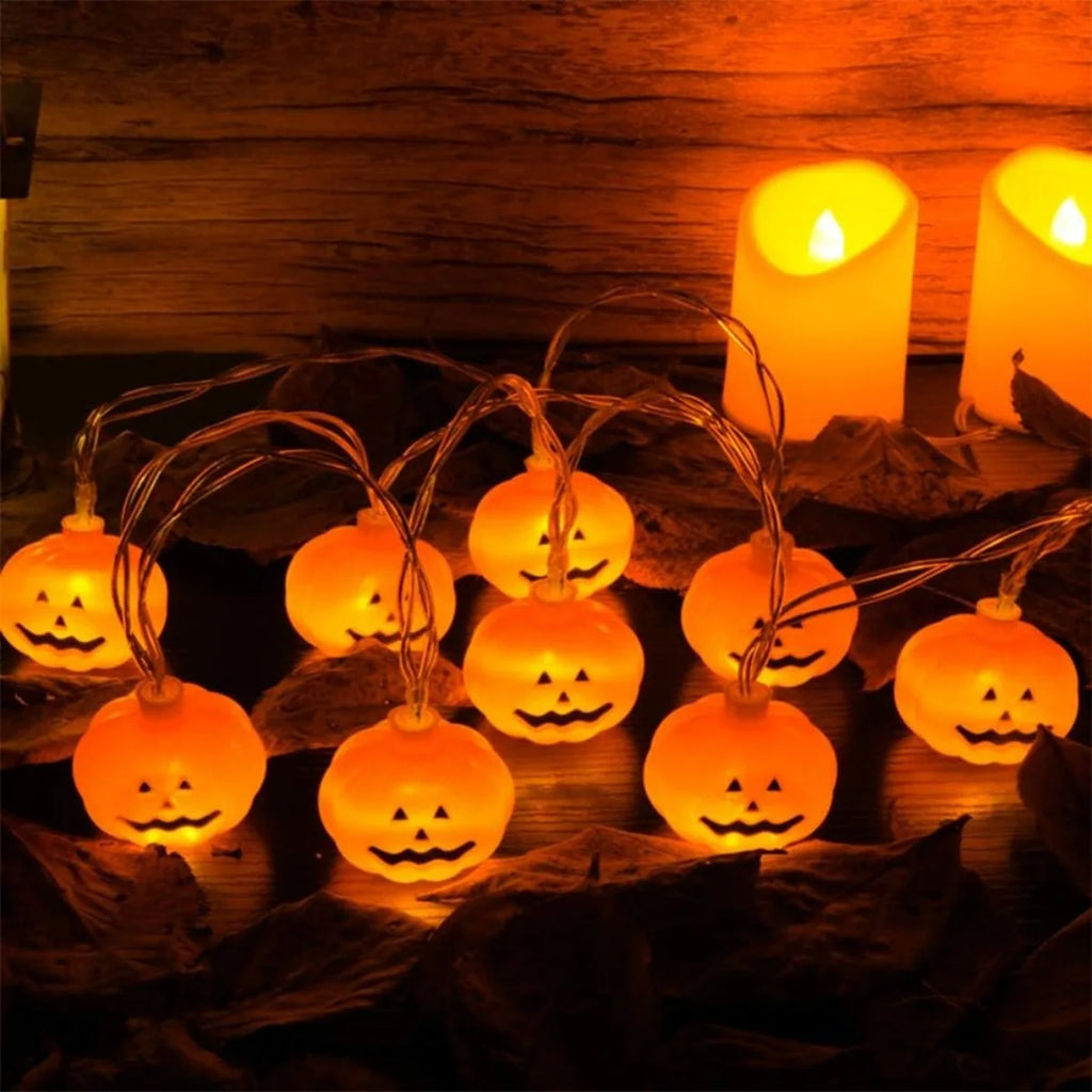 Pumpkin lights draped by candles